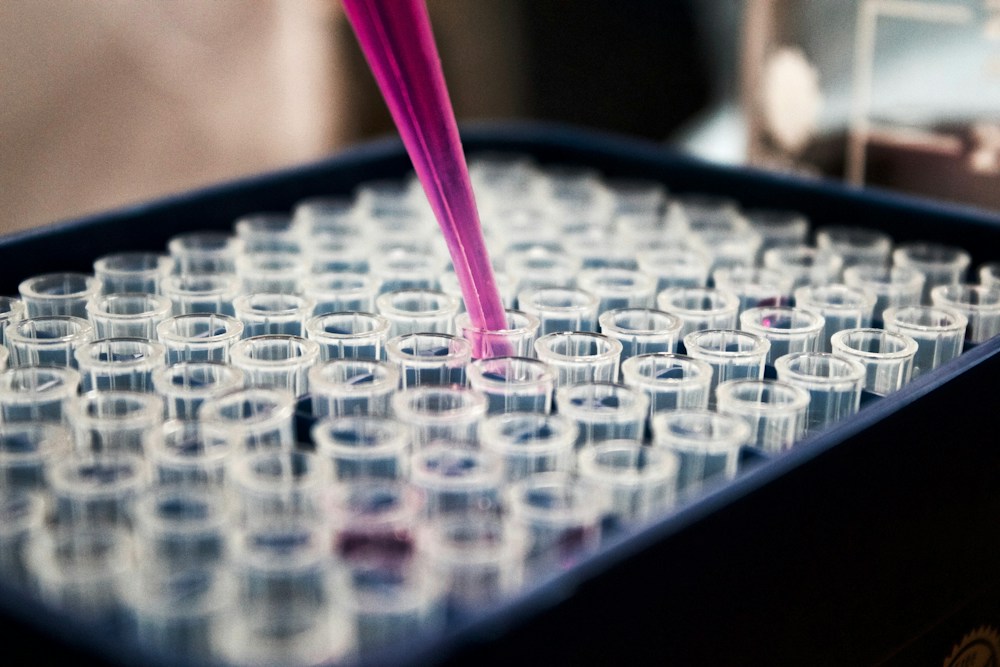 A laboratory assay plate and pipette